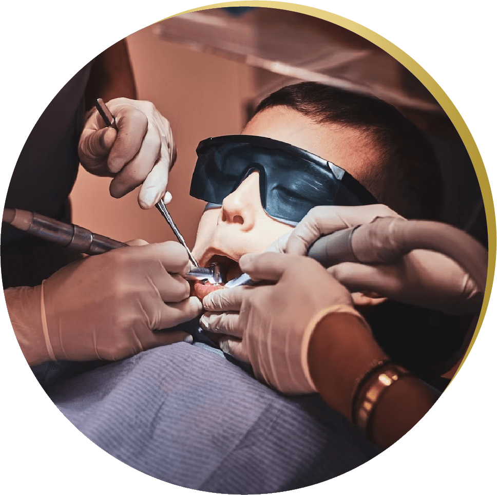A young boy wearing protective eyewear while receiving wisdom teeth removal from professionals. Pediatric dentistry for optimal oral health