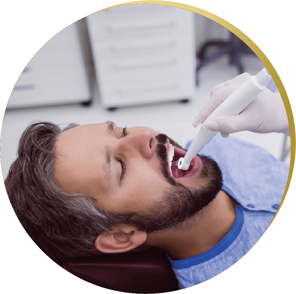 A male patient undergoes an intraoral scan preparing for wisdom teeth removal at the dentist.