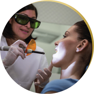 Dentist performing a laser procedure on gums – Minimally invasive laser gum treatment for periodontal care.
