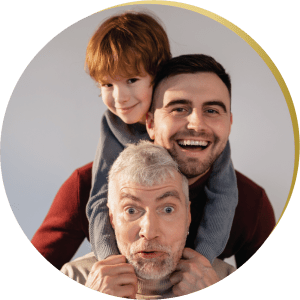 A grandfather, father, and son smiling brightly, their confident smiles enhanced by cosmetic bonding Las Vegas