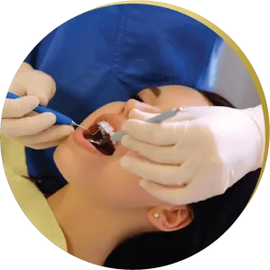 Dentist performing a tooth-colored fillings procedure on a patient in a dental chair.