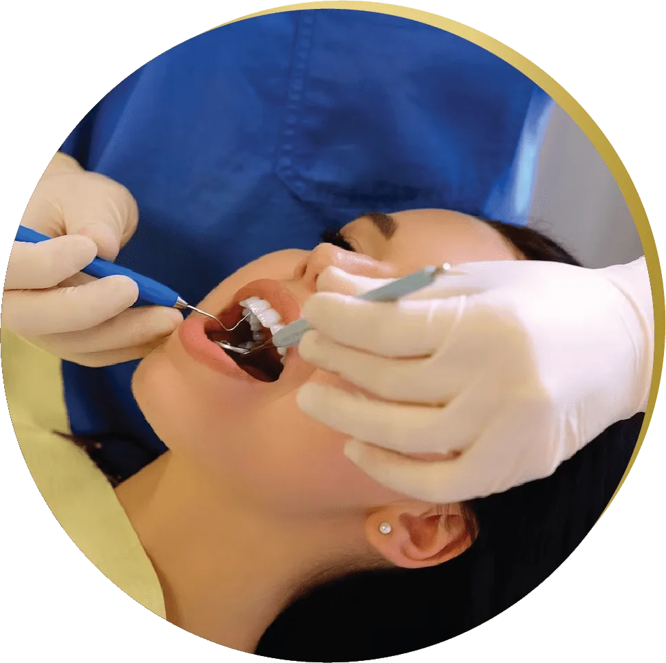 Dentist performing a tooth-colored fillings procedure on a patient in a dental chair.