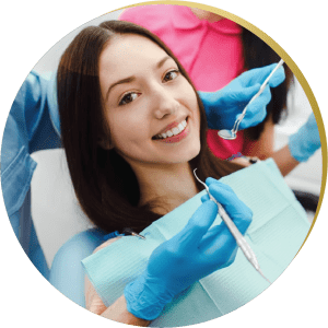 Smiling young woman at a dental appointment – A patient with a bright smile receiving consultation for inlays & onlays dental implants.