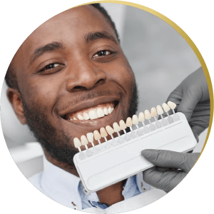 Patient undergoing a dental implants consultation, matching tooth shades for a seamless All on 4 Dental Implants restoration.