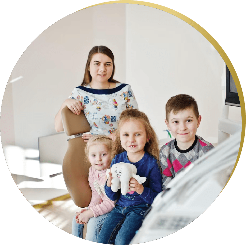 A pediatric dentist with happy children in a welcoming General and Family Dentistry office.