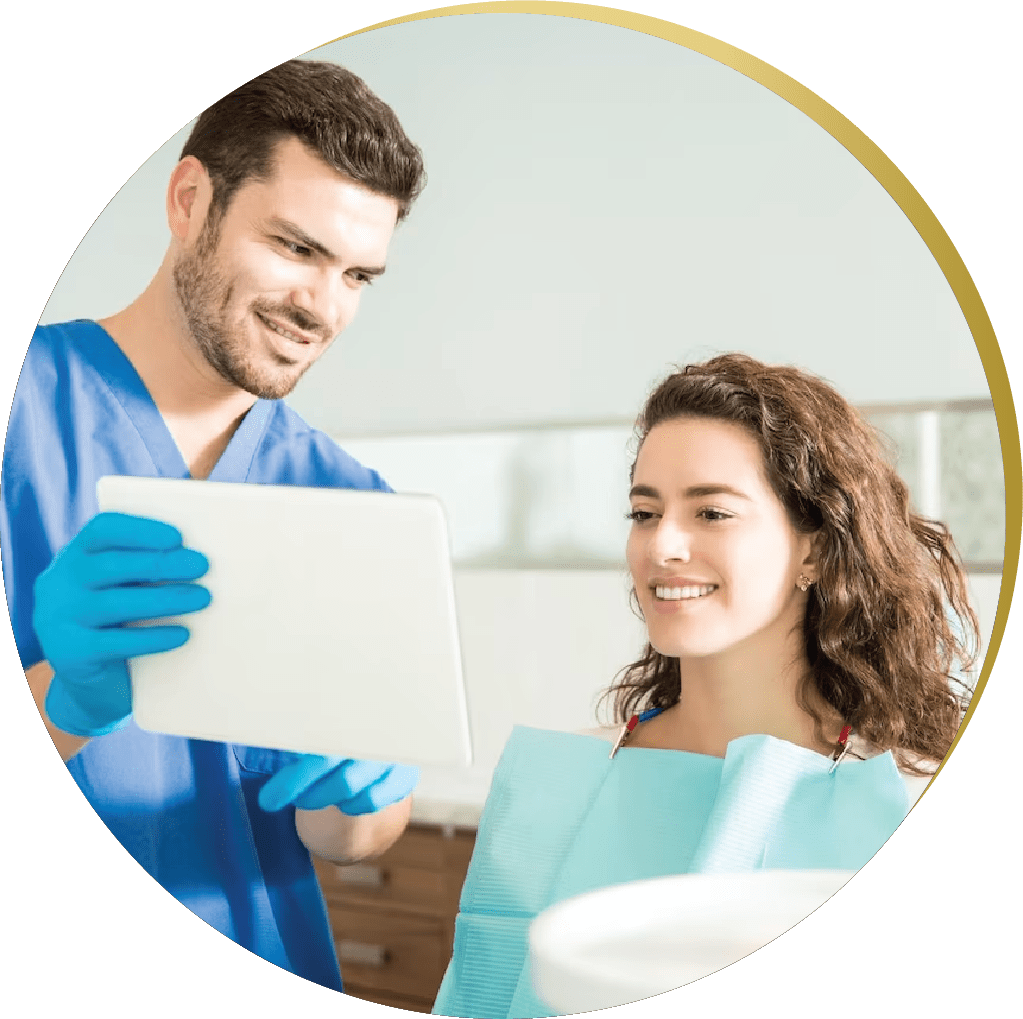 Dentist showing a smiling patient a treatment plan on a tablet in a cosmetic dentistry clinic.