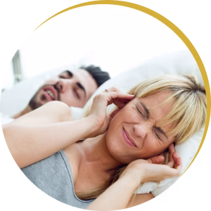 Frustrated partner unable to sleep due to loud snoring, highlighting need for sleep apnea treatment.