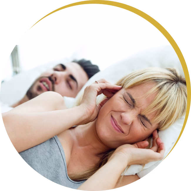 Frustrated partner unable to sleep due to loud snoring, highlighting need for sleep apnea treatment.